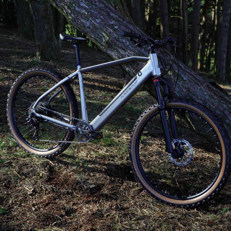 Claud Butler Ridge 2.0 lifestyle leaning against a tree in a forest setting