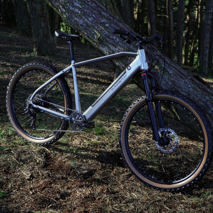 Claud Butler Ridge 2.0 lifestyle leaning against a tree in a forest setting