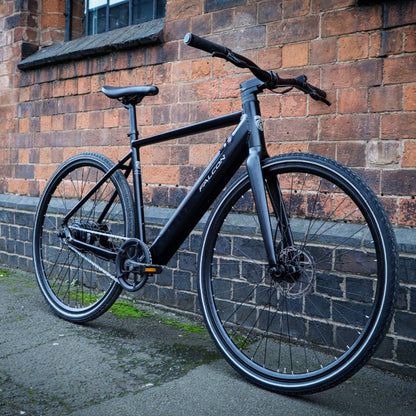 Falcon Zone Hybrid e-bike lifestyle city leaning against a brick wall