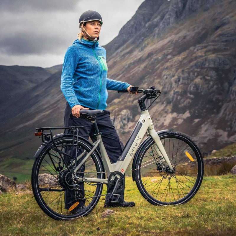 Person with a Hygge Nivo Grey bicycle in a mountainous landscape