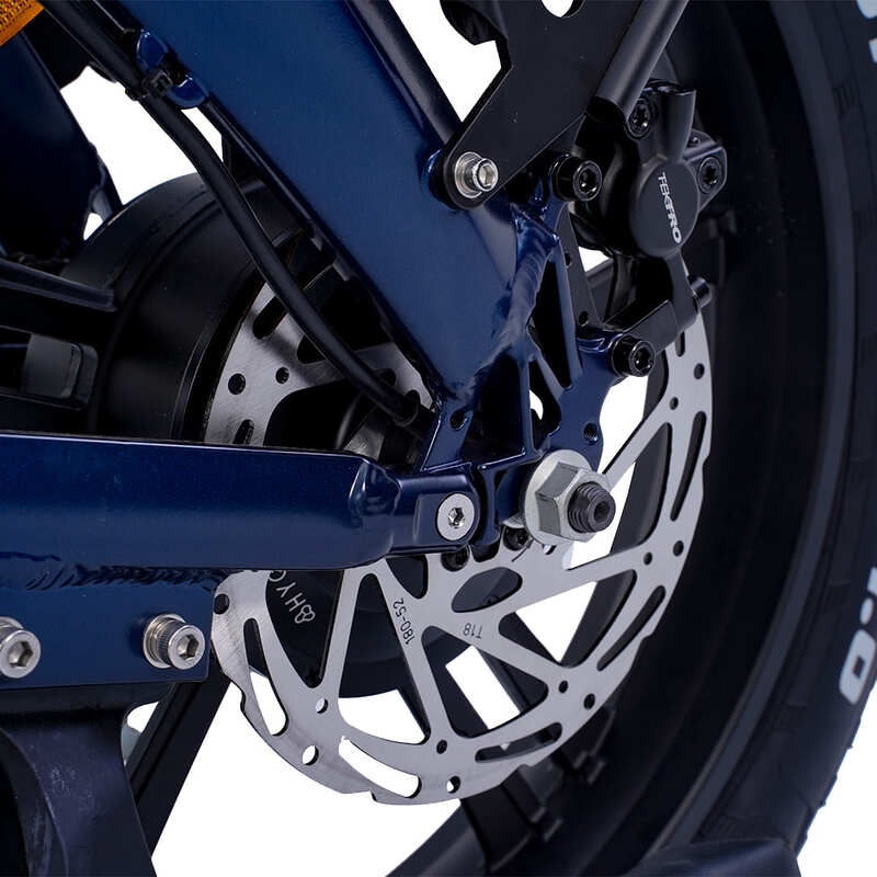 Hygge Soro Close-up motor, disc brake and blue suspension fork on a white background