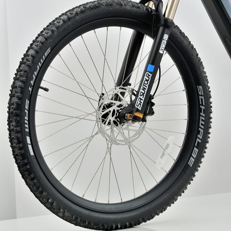 Revom M1 eMTB front wheel Close-up with Schwalbe tires on a white background