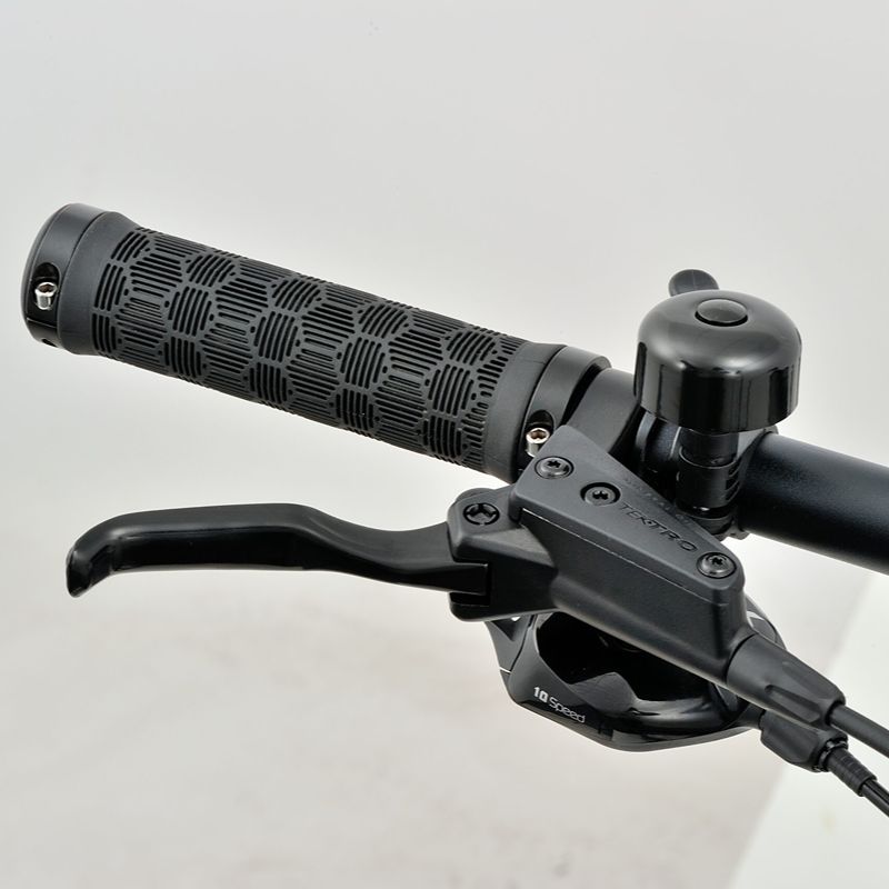 Revom M1 eMTB Close-up handlebar with black grips and controls on a light grey background