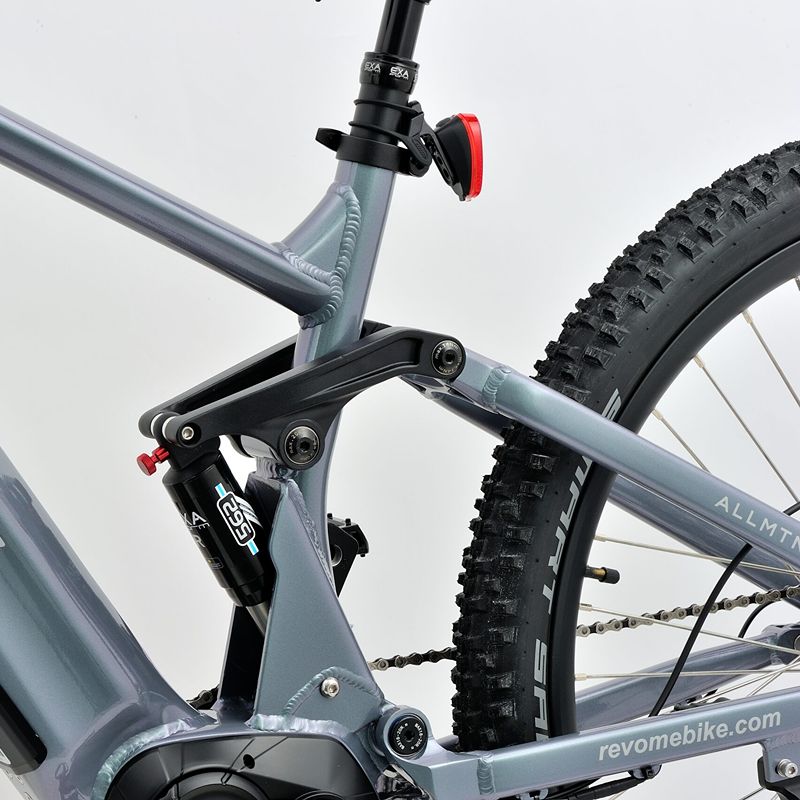 Revom M1 eMTB suspension Close-up with visible branding on a light grey background