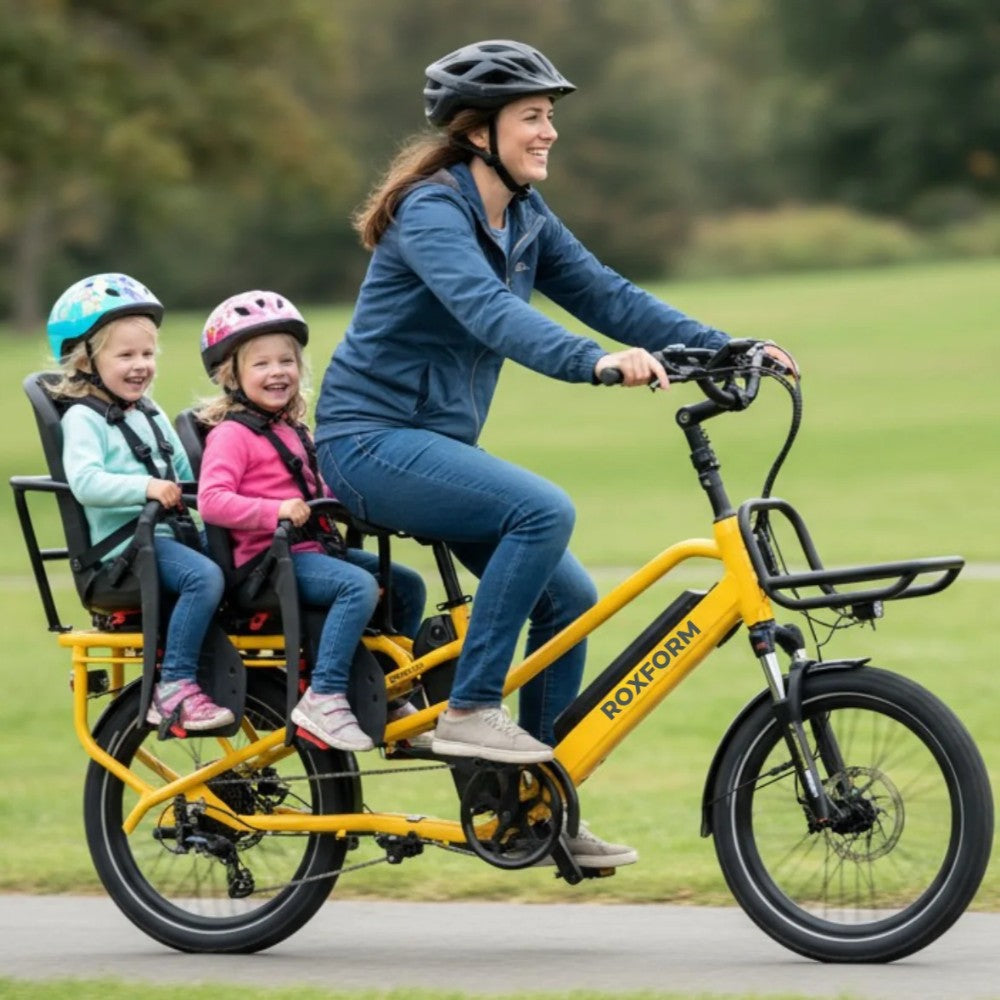 Roxform_Porto_family_cargo_ebike Woman riding with two children in a park
