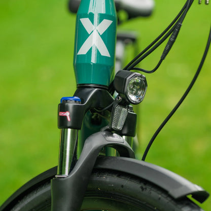 Roxform Valor S e-bike front light Close-up on a blurred green background