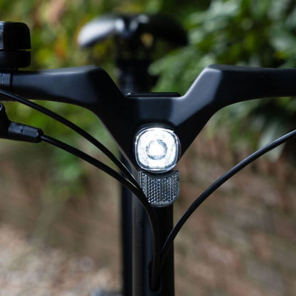 e-go CarbonLite3S headlight close-up with a blurred natural background